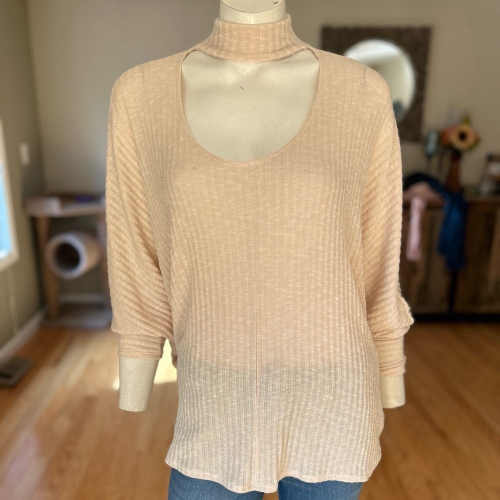 A sweater blouse with a key hole neck